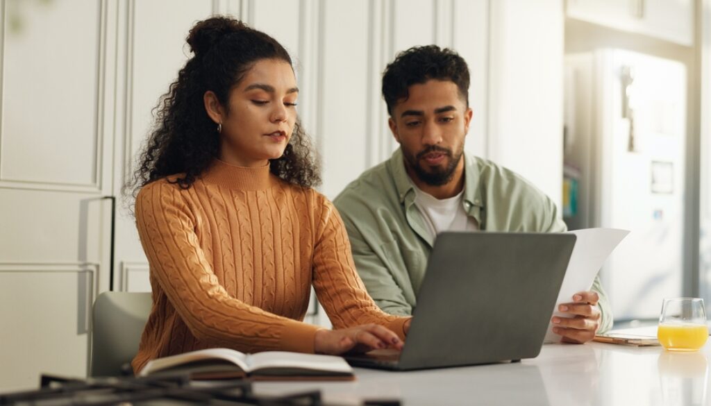 Laptop,,Documents,And,Typing,With,Couple,In,Kitchen,For,Bills,
